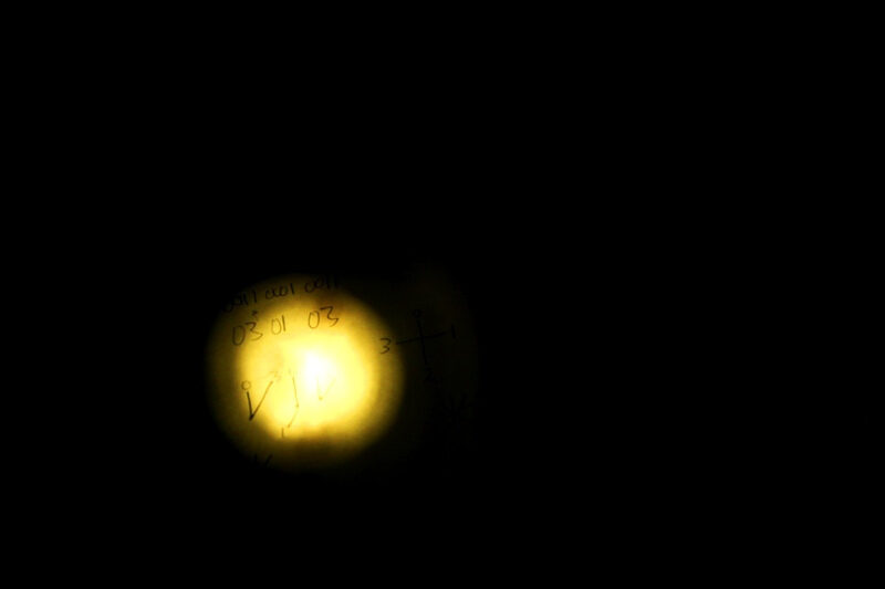 A dimly illuminated note page